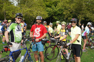 A group of four Bike-A-Thon riders smiling with their bikes before departing on their route.